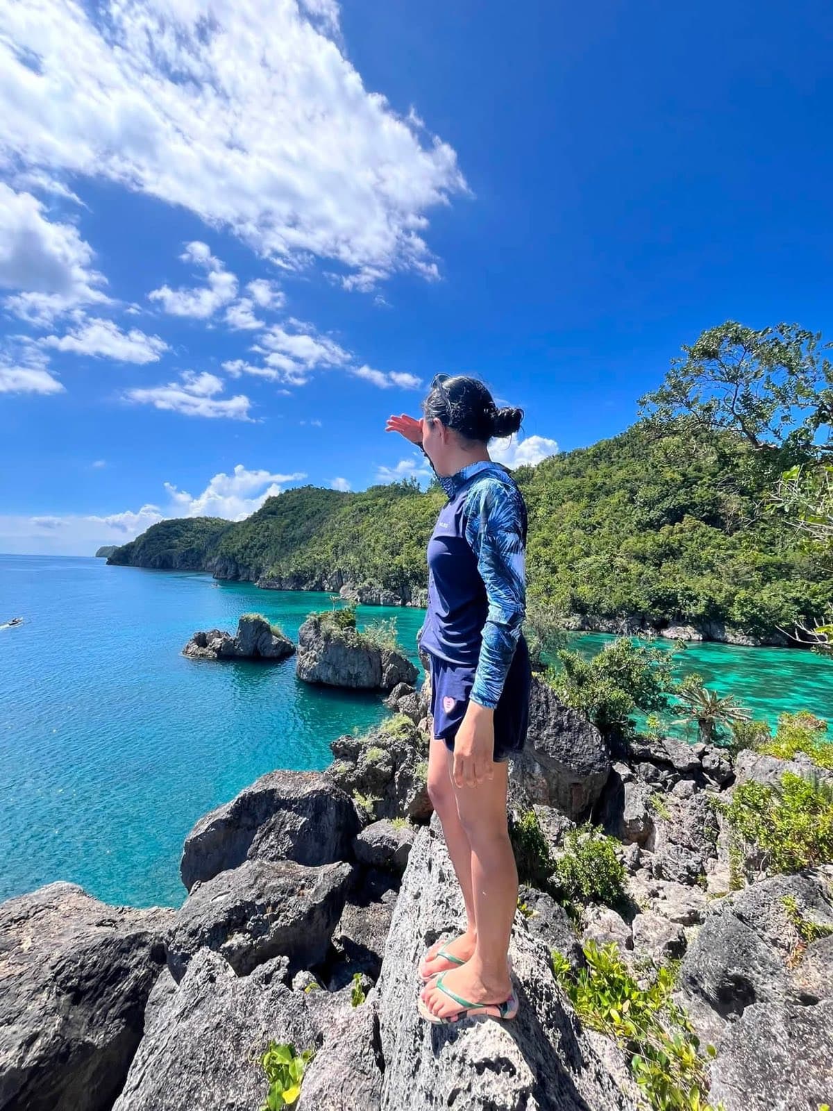 A guest looking out over a turquoise lagoon and limestone islets on a Ticao Island day trip